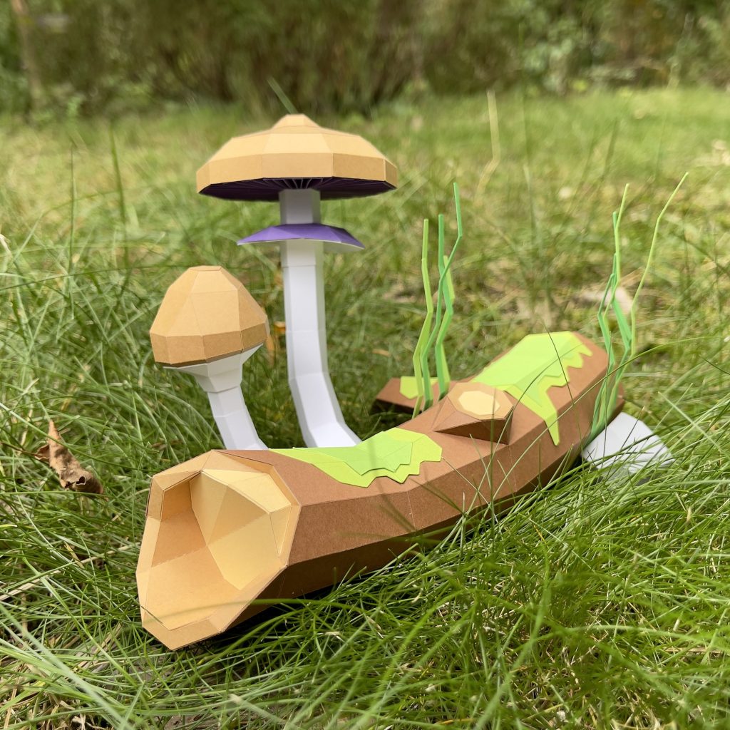 Papercraft of shrooms: Psilocybe cubensis on grass